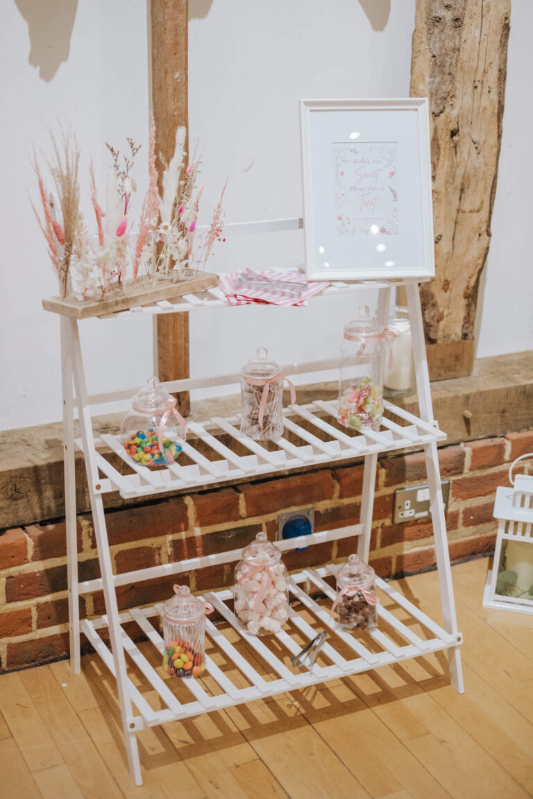 White shelf treat stand against a brick wall