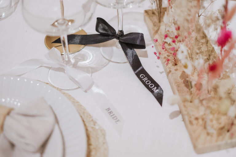 Place setting with a ribbon-tied glass
