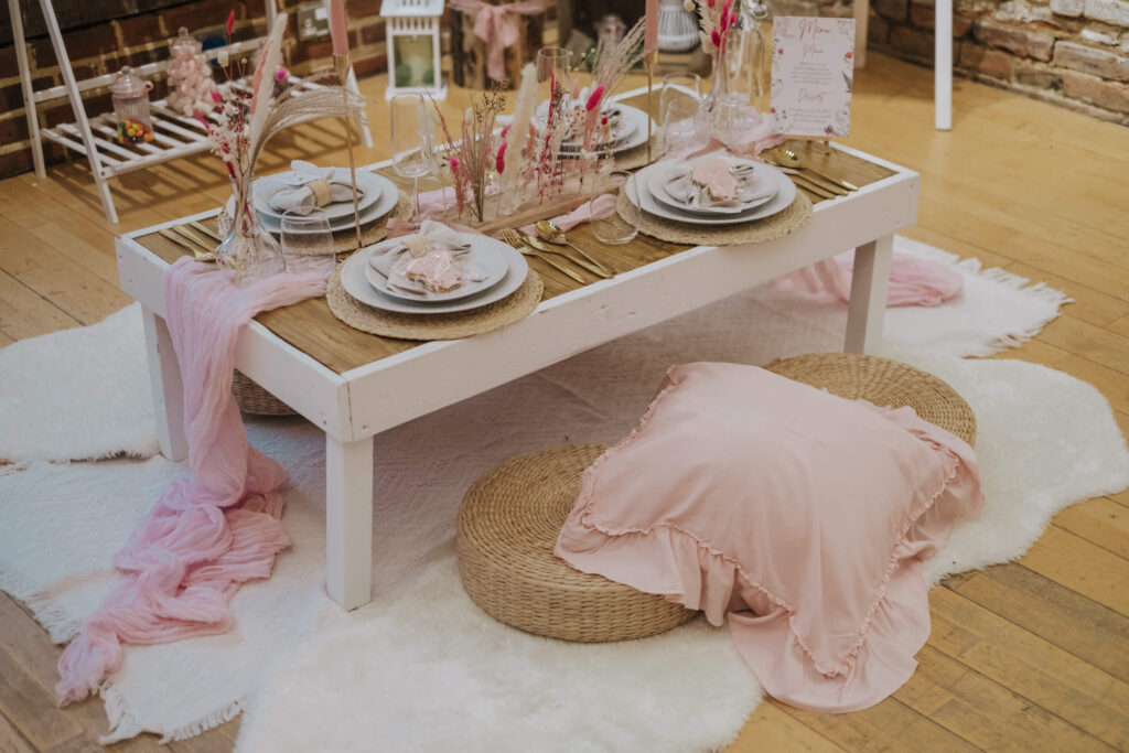 Kids picnic table styled on a cowhide rug with personalised place settings